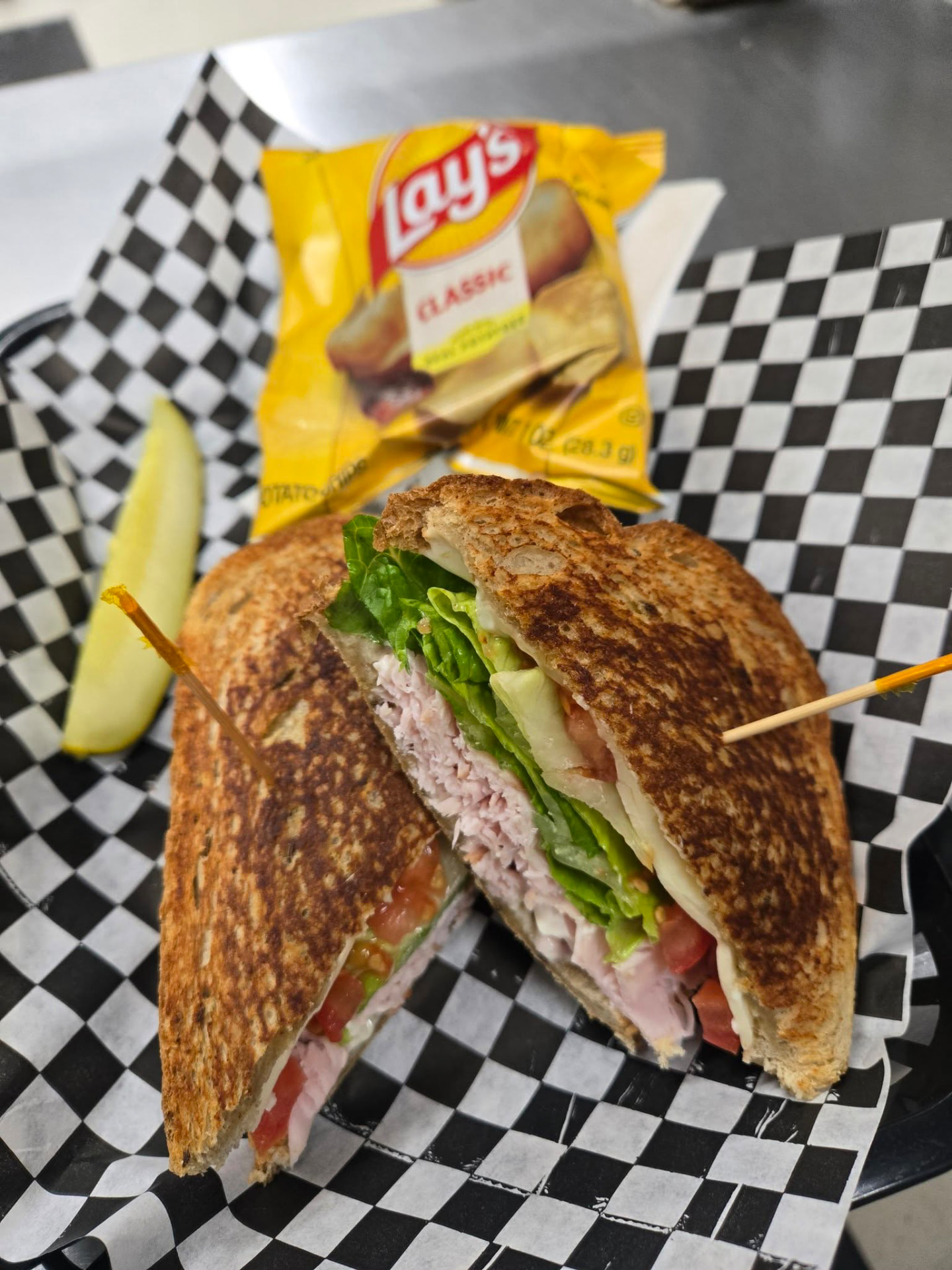 Toasted lunch sandwich served on checker paper at Mi-Lady Bakery