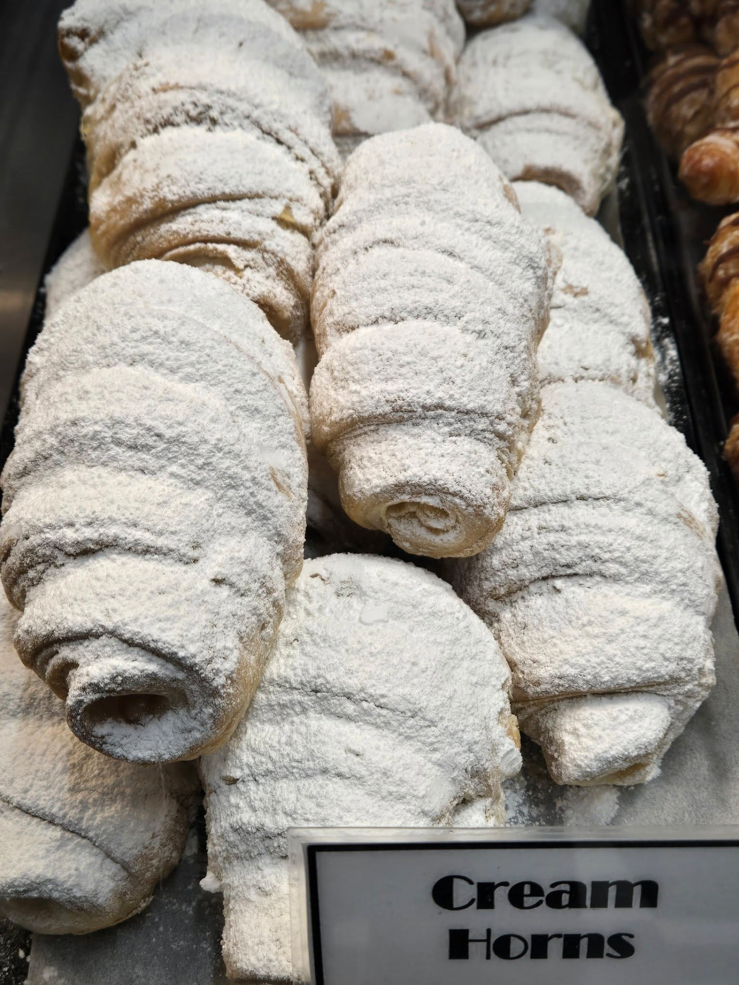 Powdered cream horns in the Mi-Lady Bakery display case